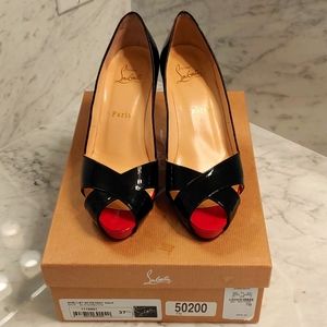Sexy Christian Louboutin peep-toe pumps in black patent leather.